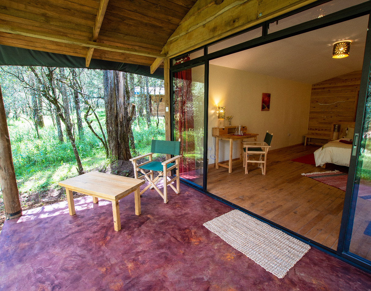 Guest cabin interior and veranda at Cedar Retreat in the Aberdare Region