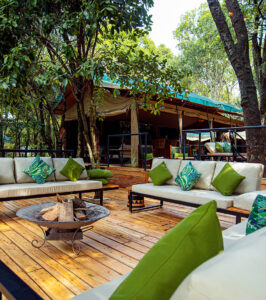 Sofas and tables in the outdoors common area at Serenity Mara Legends-