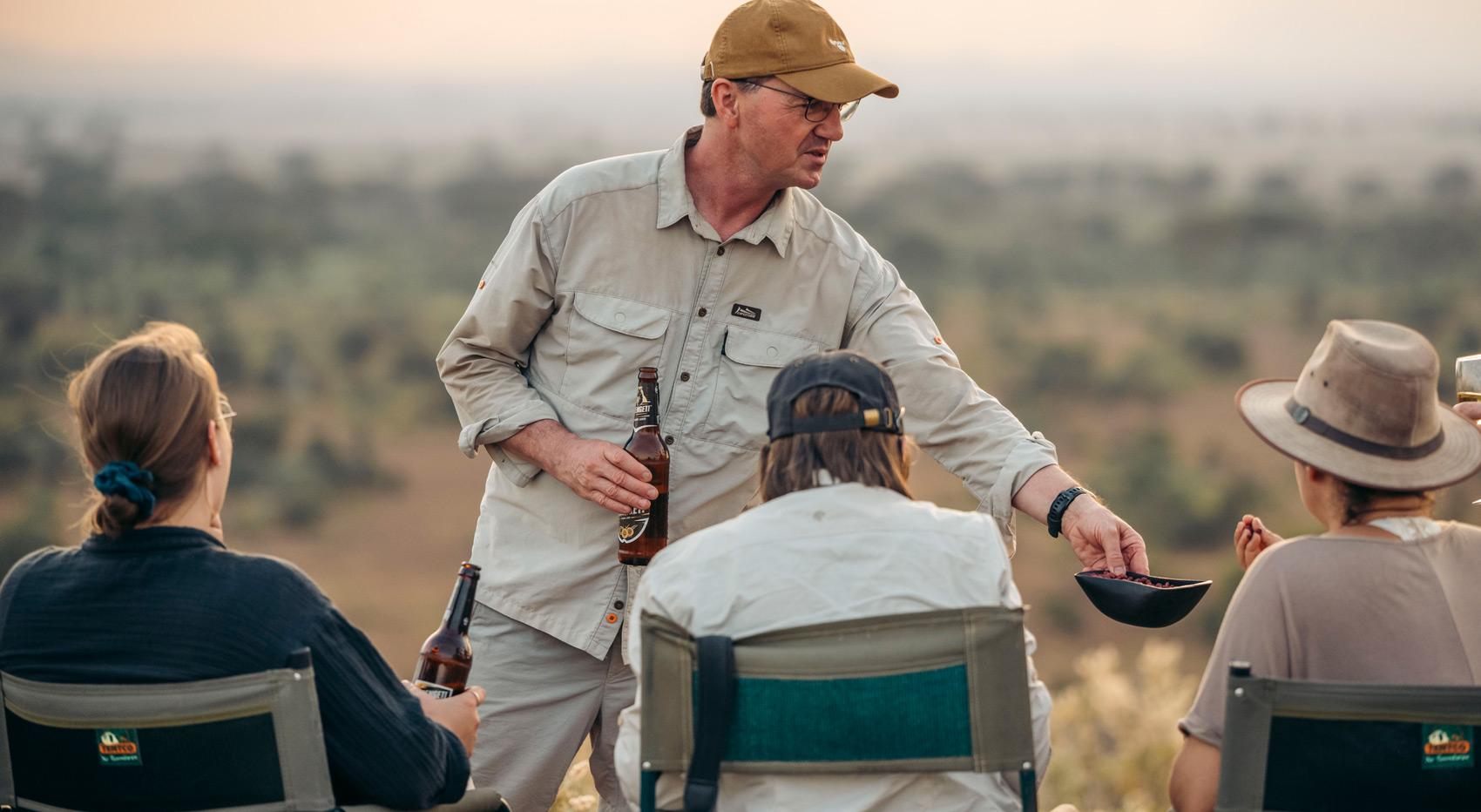 Guests enjoying sundowners in the bush. Guests enjoying sundowners in the bush.