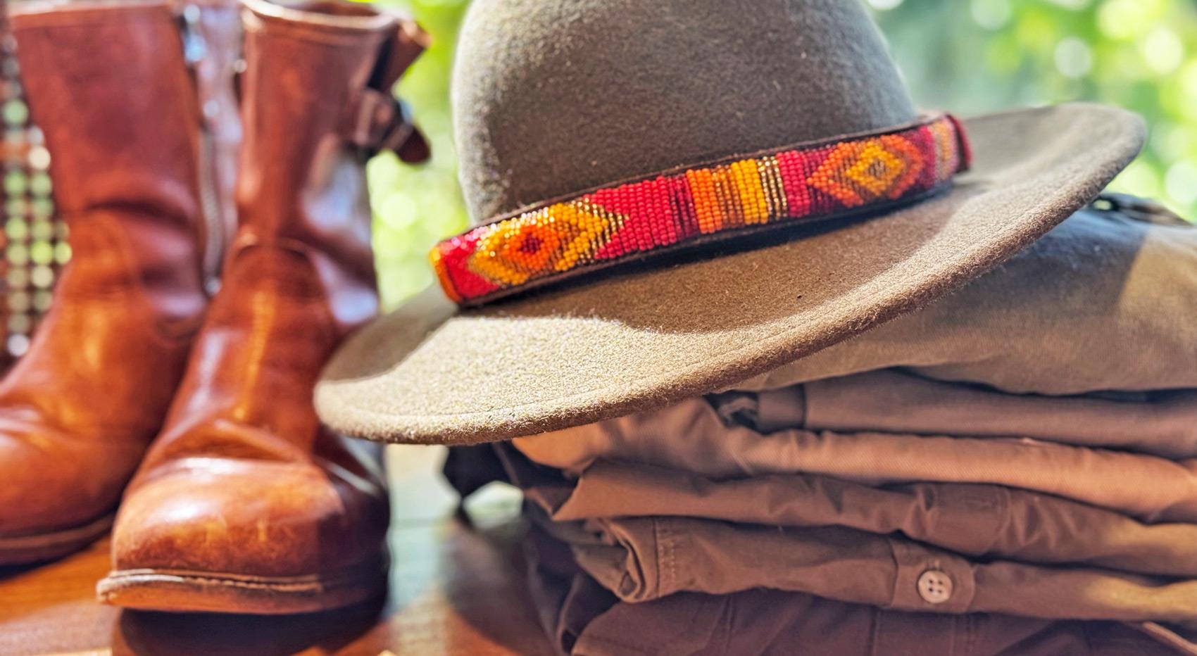 A photo showing what to wear on safari in kenya: boots, a wide brimmed hat and clothes for a safari. A photo showing what to wear on safari in kenya: boots, a wide brimmed hat and clothes for a safari.
