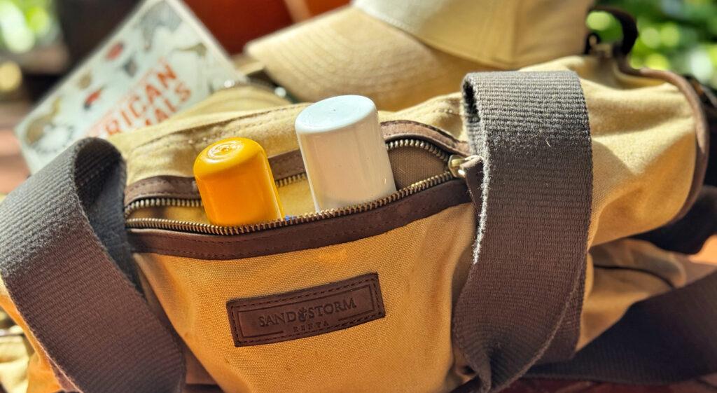 A safari vehicle with guests in Samburu next to an elephant herd.