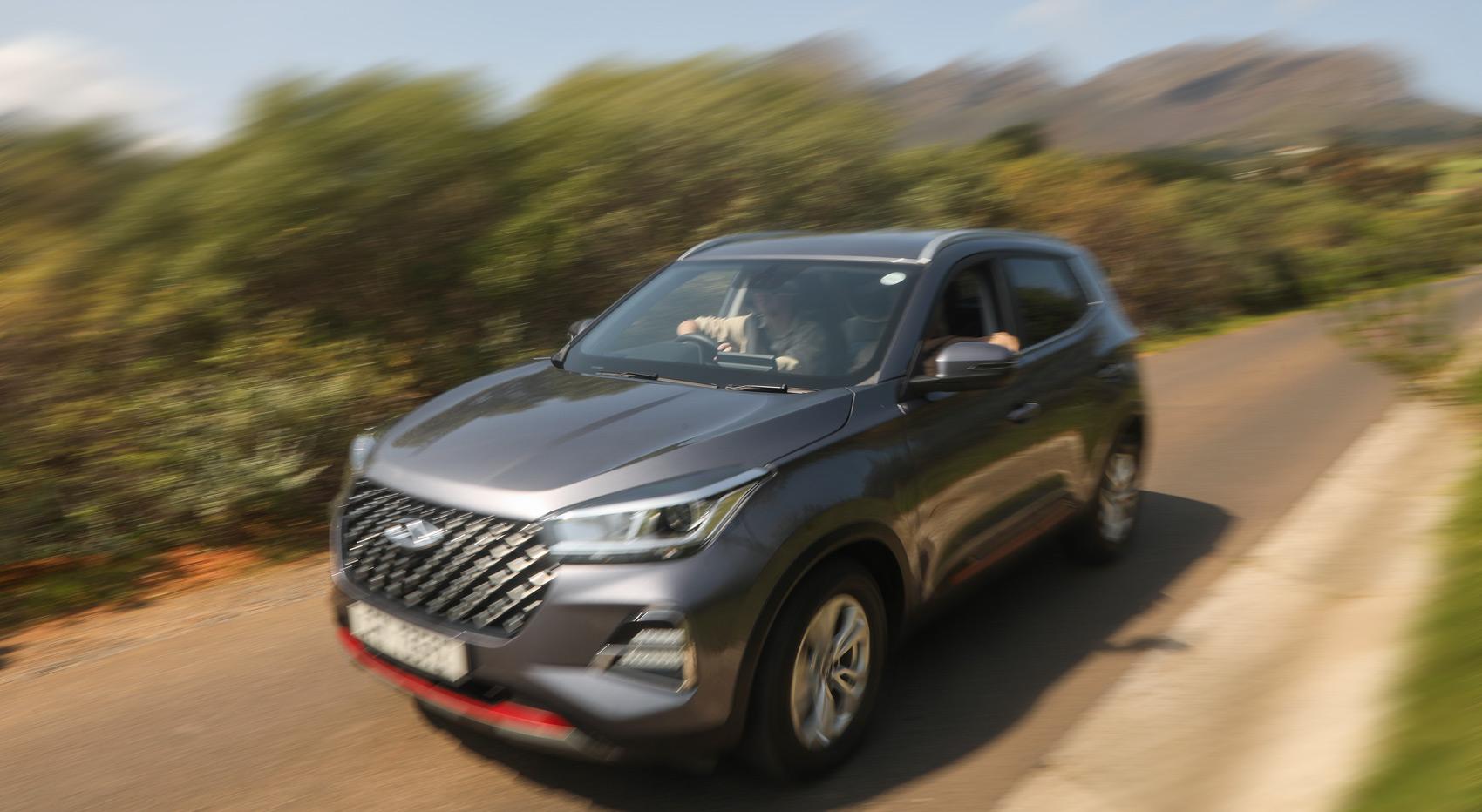 A blurry image of a rental car driving along the road in the winelands.