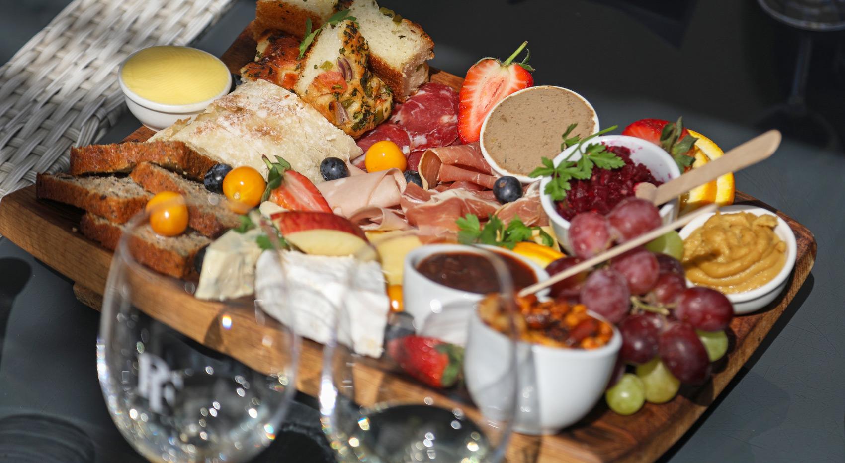 A charcuterie-board with wine glasses in South Africa.